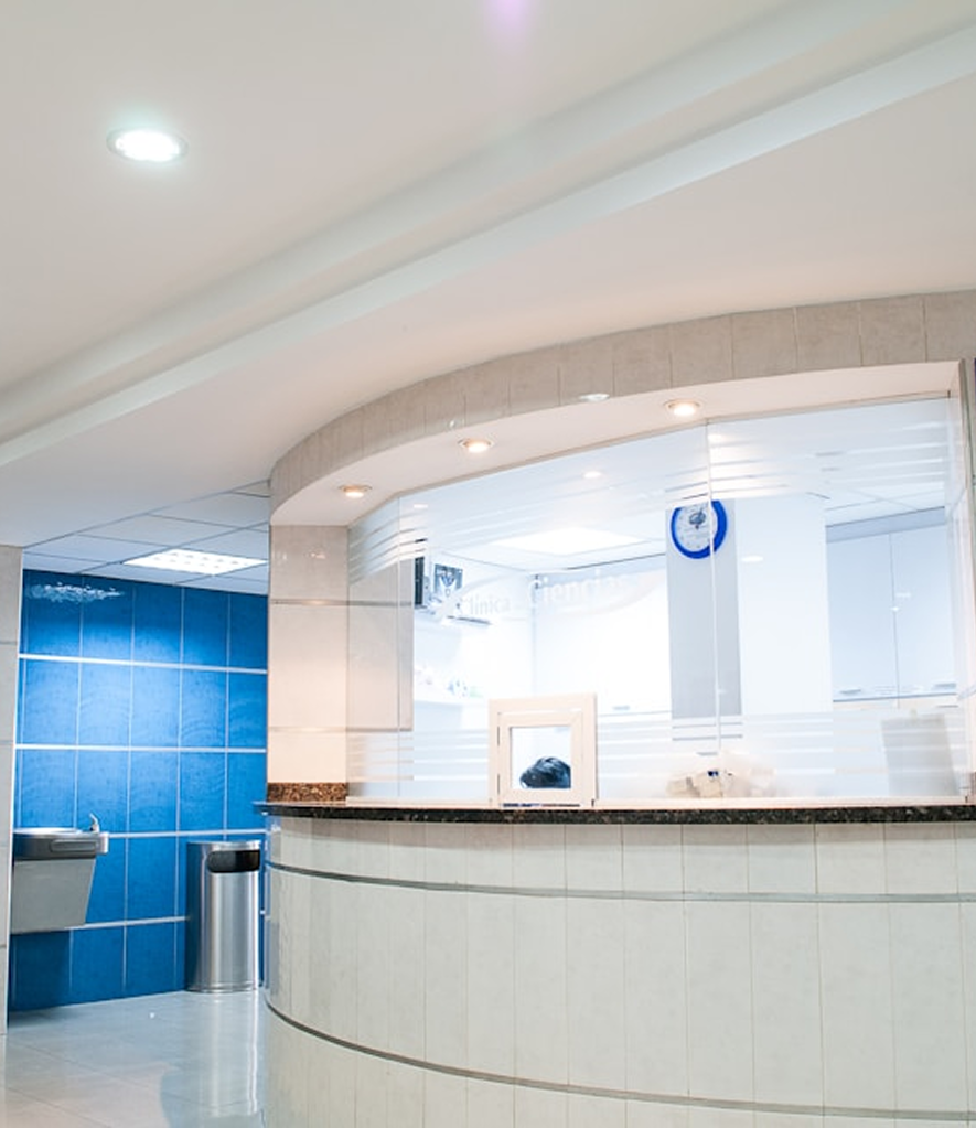 Uma recepção de uma clínica médica, com tons de branco e paredes azuis